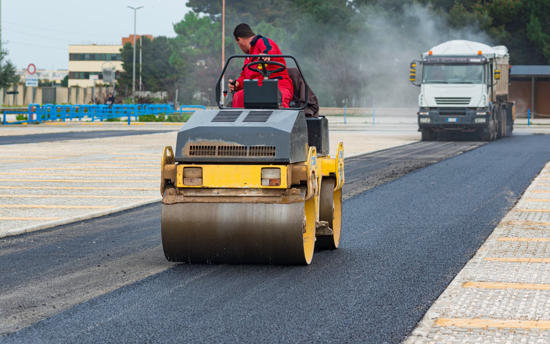 Roller compacting a newly paved asphalt parking lot in Toms River, NJ