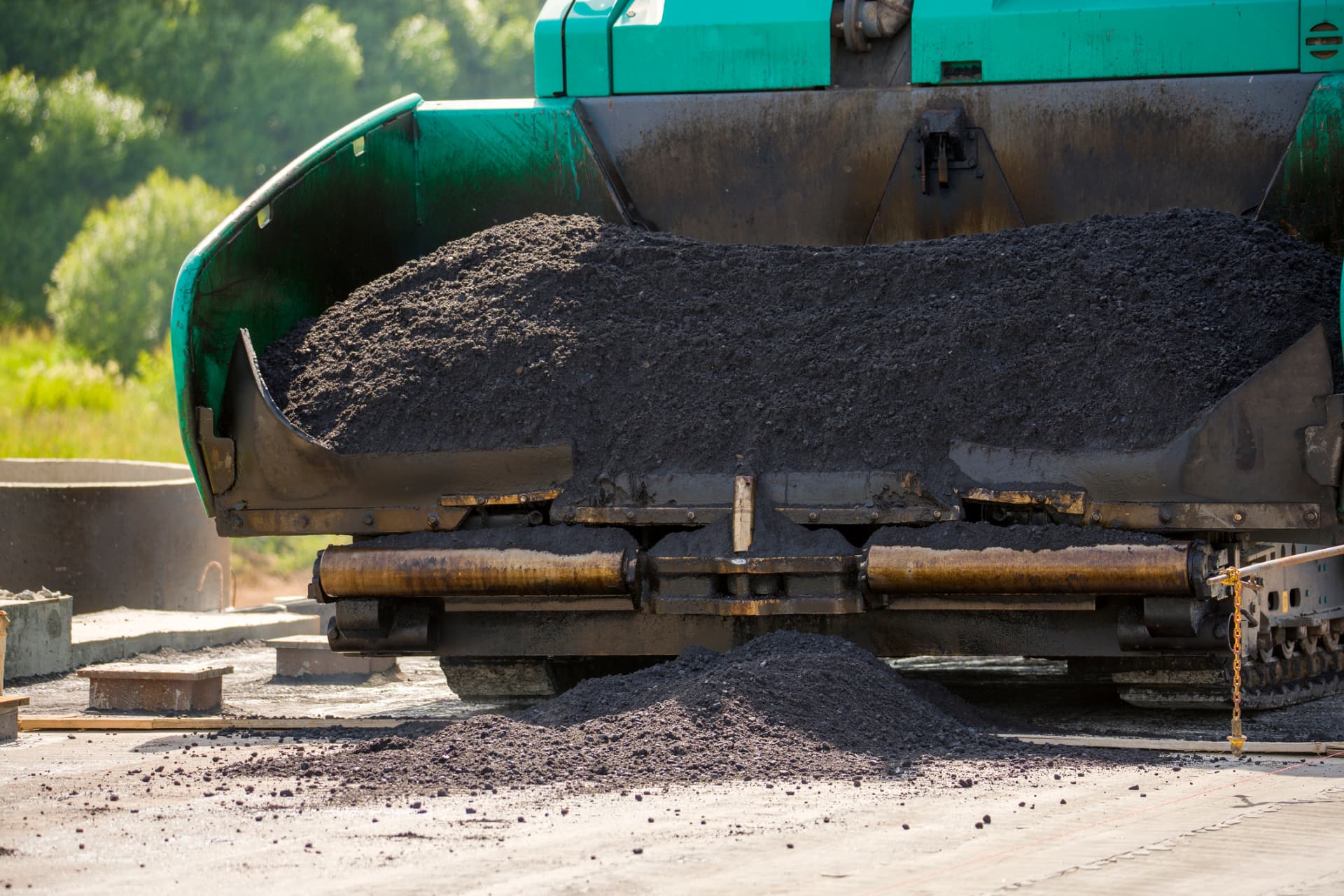 Hot-mix asphalt flowing from a paver hopper on a Freehold, NJ paving job