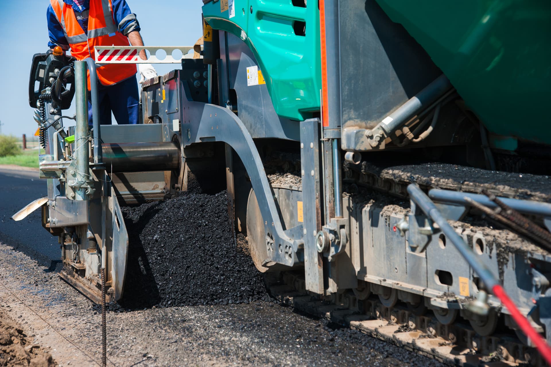 Asphalt paver screed laying a fresh mat of hot mix on an Edison roadway