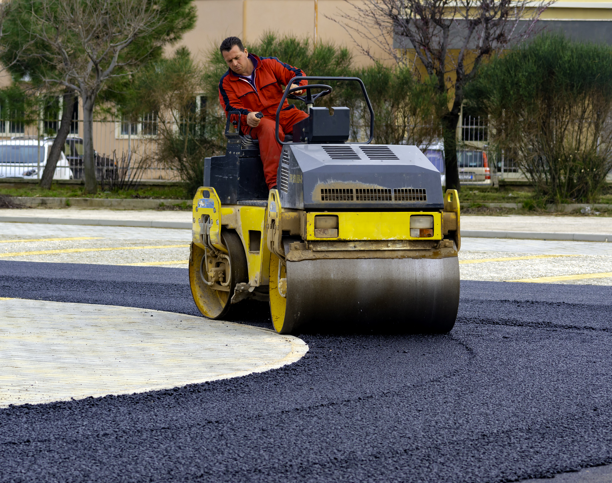 Asphalt roller compacting a freshly paved parking lot in Toms River, New Jersey