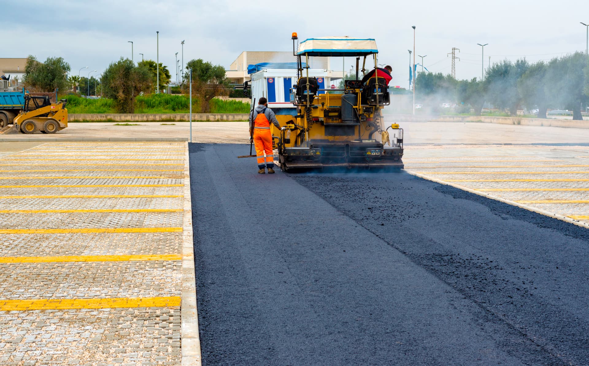 Paving machine resurfacing a large commercial parking lot