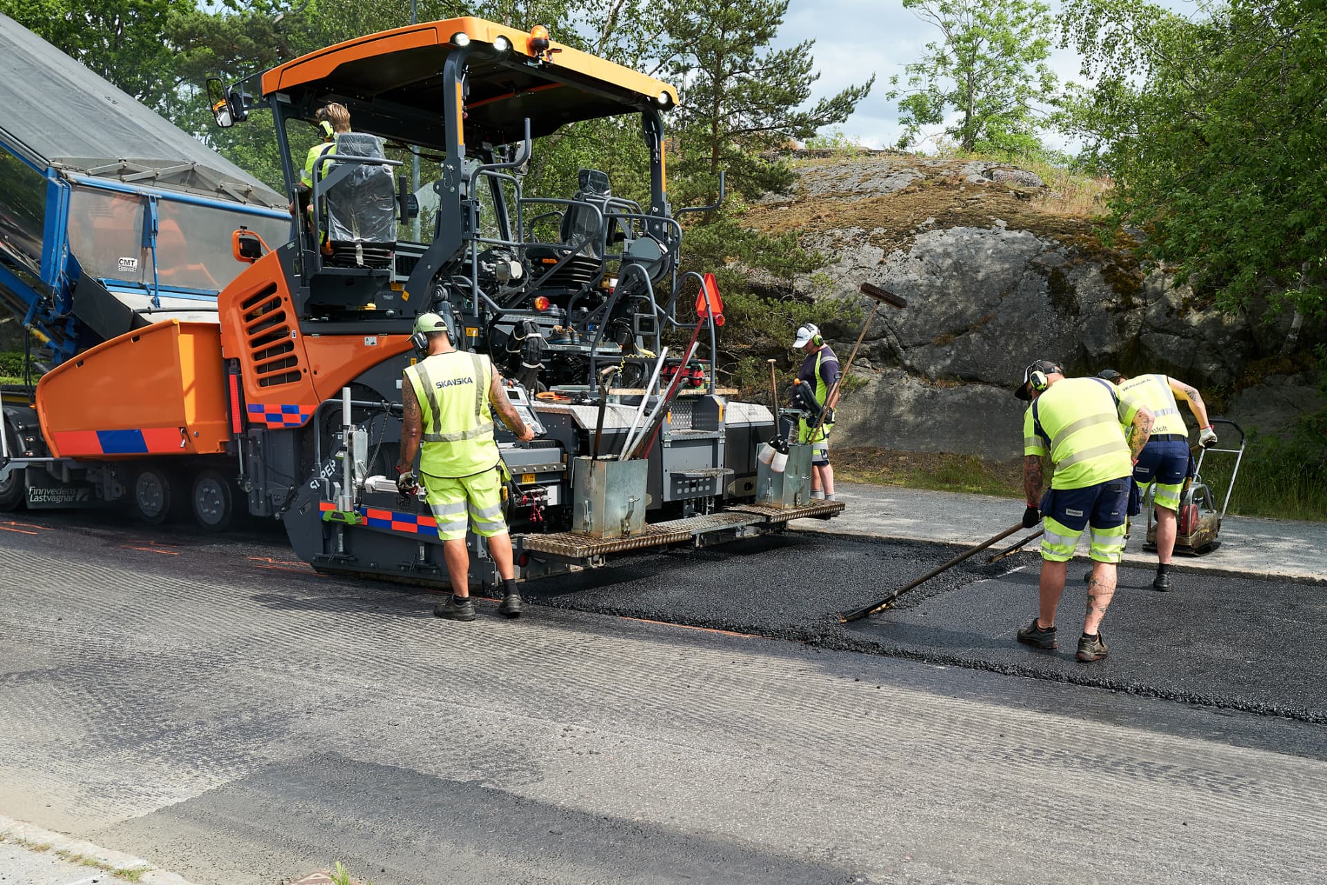 Paving crew laying hot-mix asphalt on a street in Edison, New Jersey
