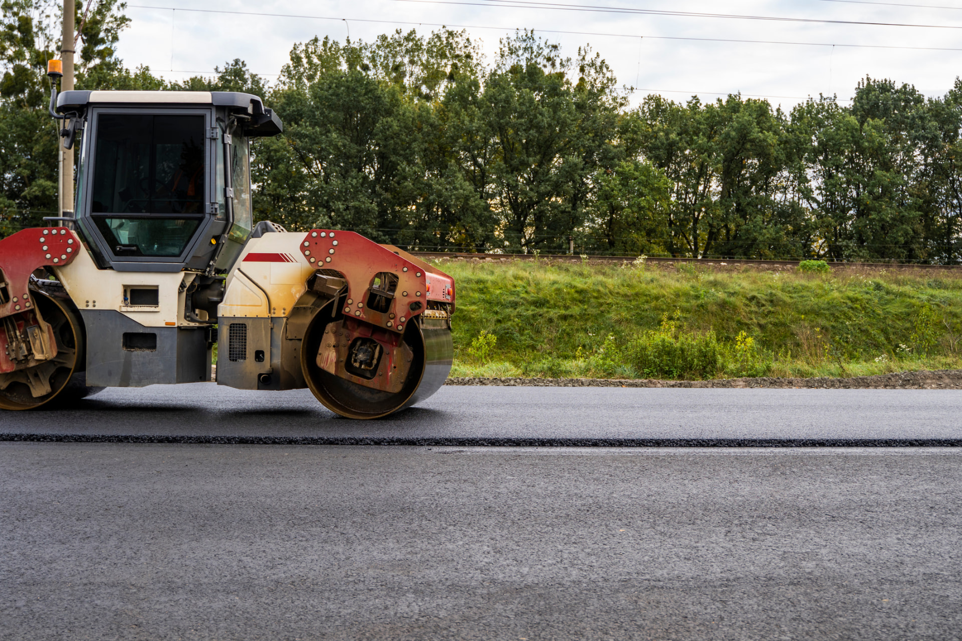 Roller compacting a newly paved roadway on a New Jersey resurfacing project