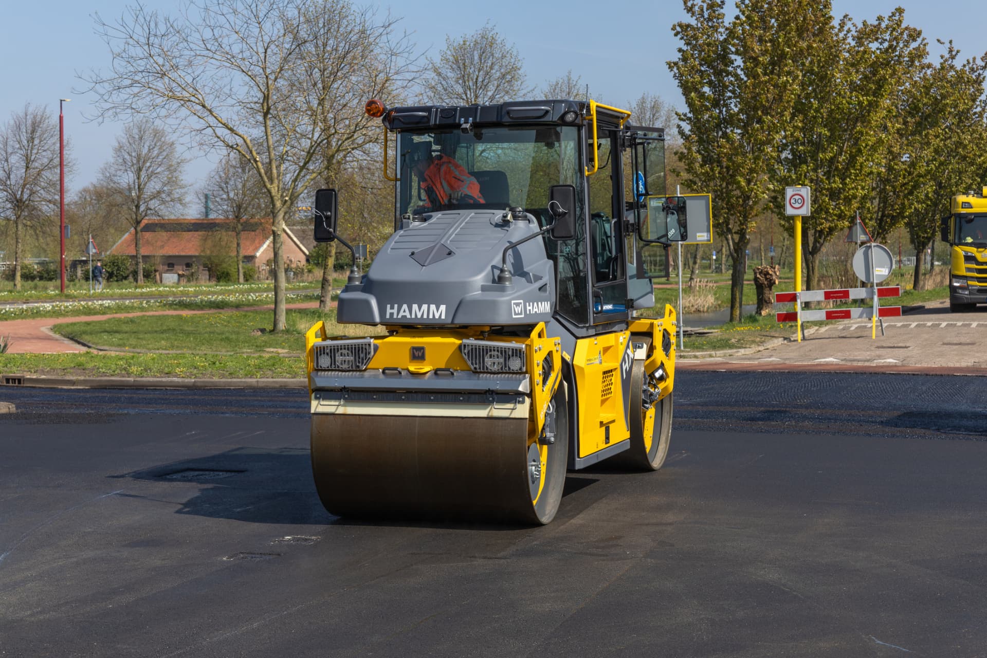 Tandem roller compacting a newly paved surface on a Freehold project
